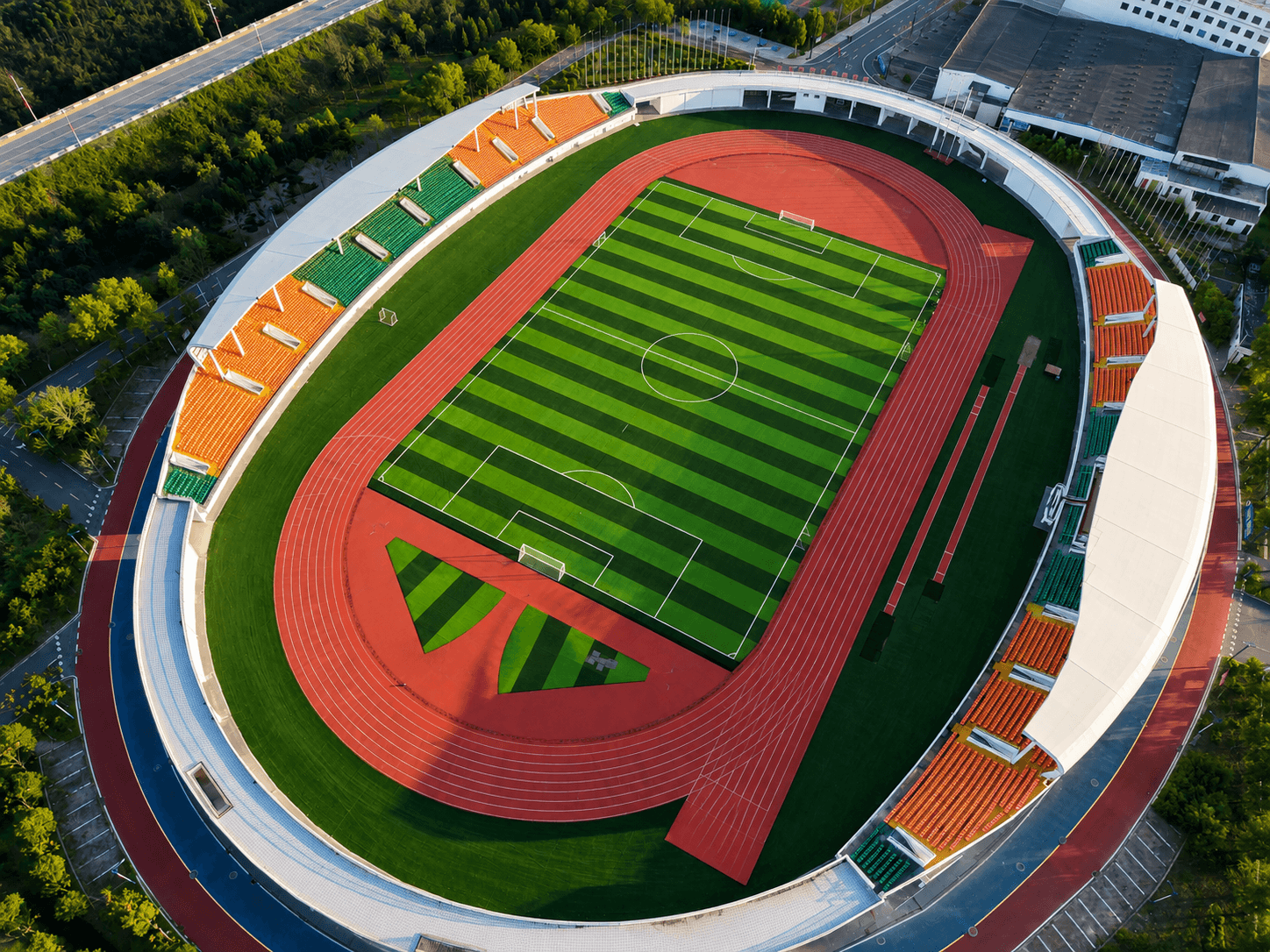 Stadium under construction with running track and seating