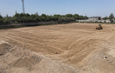 Empty graded ground before turf pitch installation